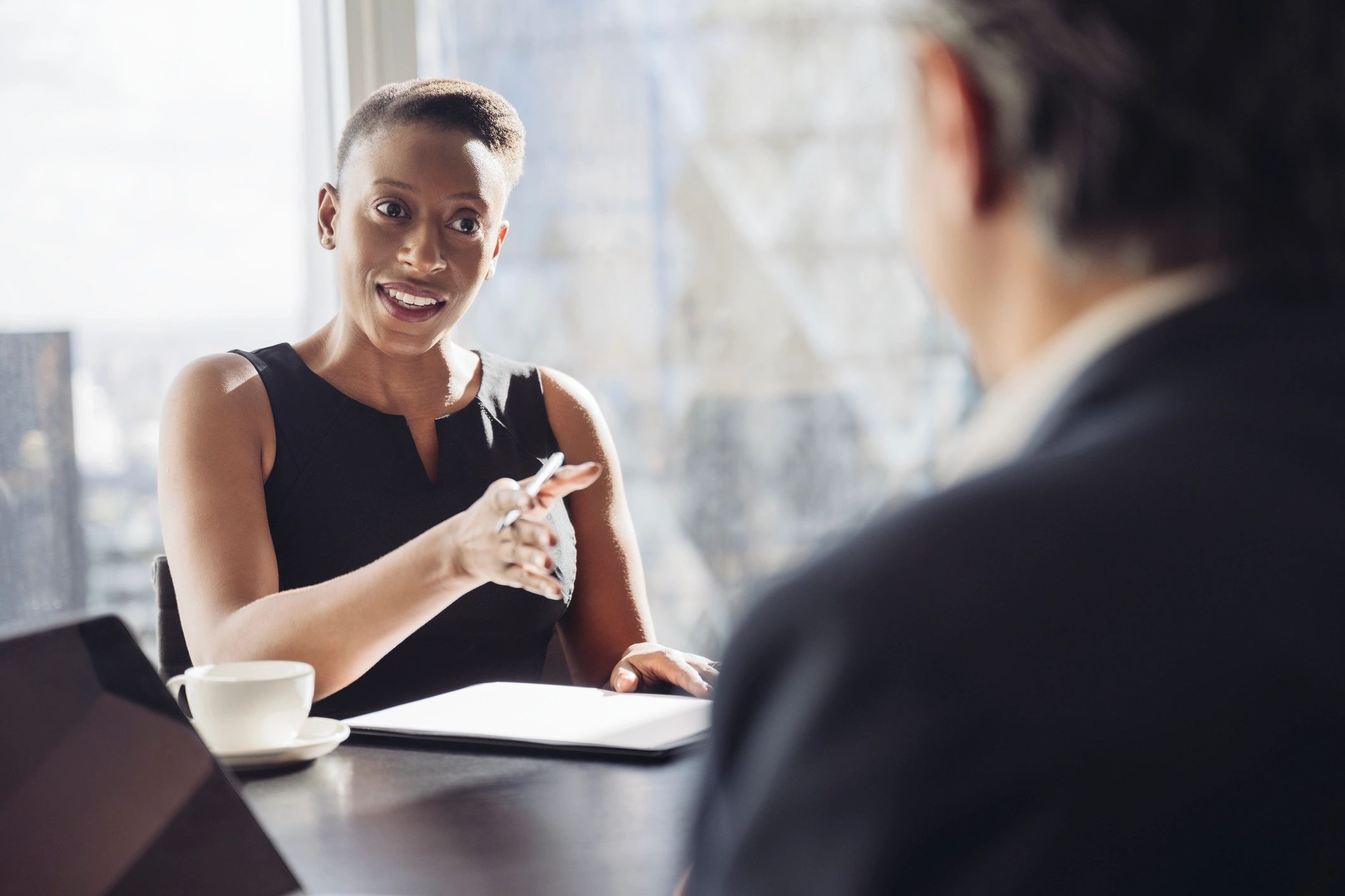 Professional meeting between notary and client at a table