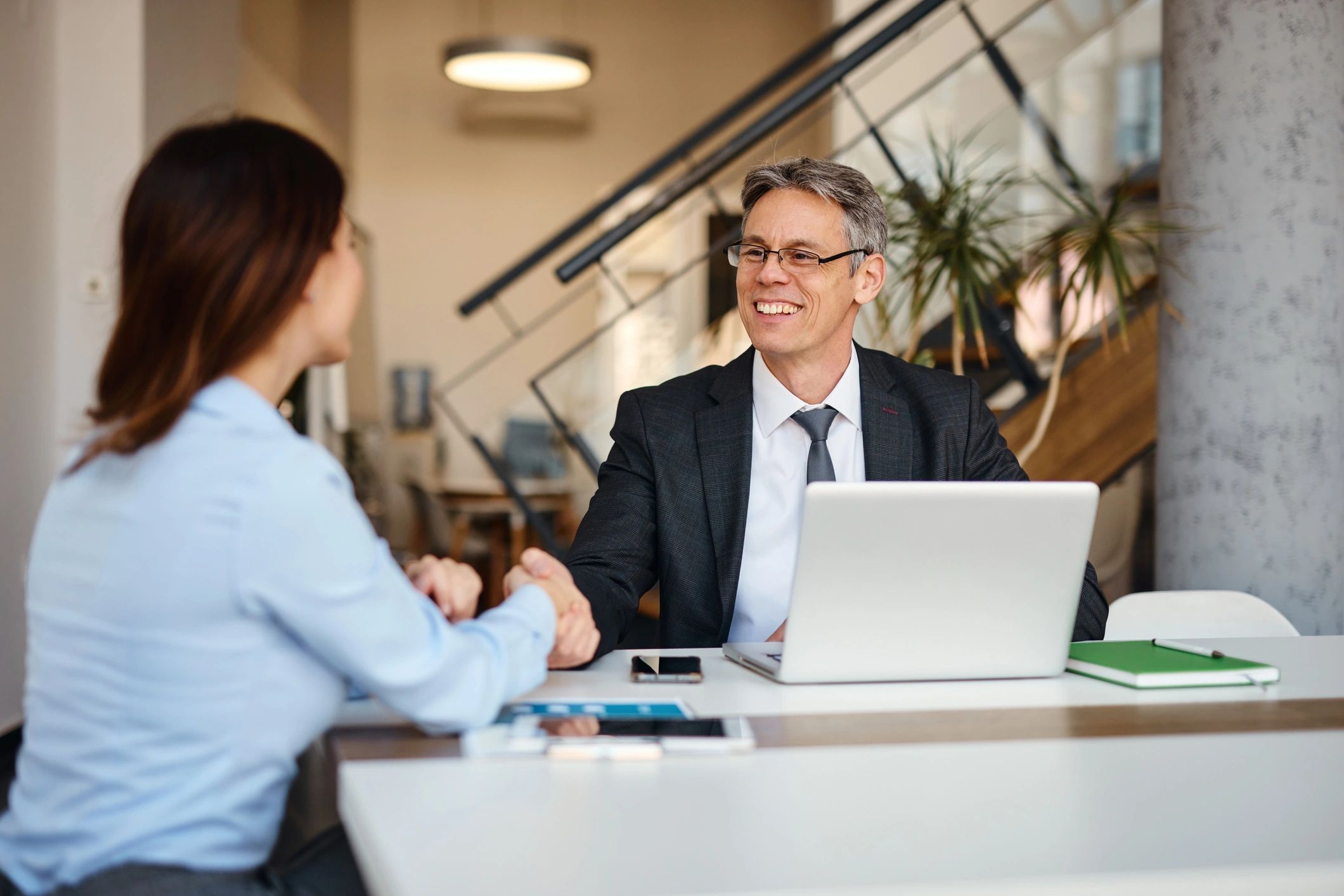 Two professionals shaking hands after a meeting